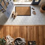 hardwood flooring transitioning to hexagonal tile in entryway