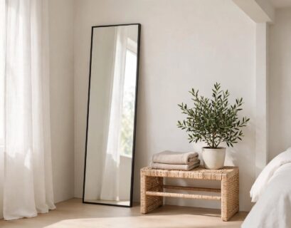 Tall thin-framed long mirror leaning against a bedroom wall